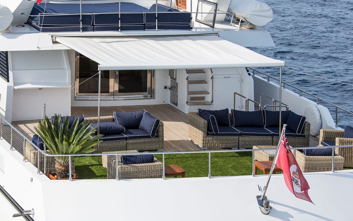 Motor yacht MIRAGGIO aerial shot of top deck with wicker seating and parasoli
