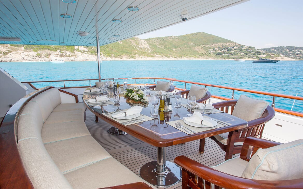 Motor yacht MIRAGGIO decking shot with dining table and seating for 10
