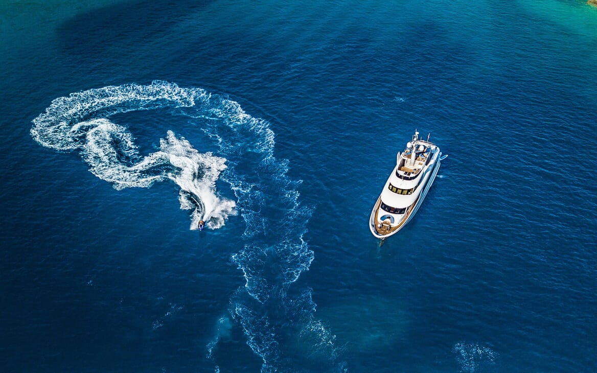 Motor yacht Milaya high aerial shot with jetski on water