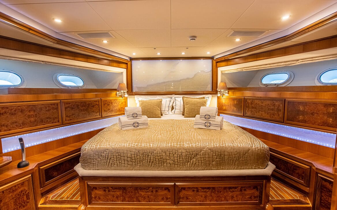 Motor yacht Milaya double bed cabin with gold and white bed linen