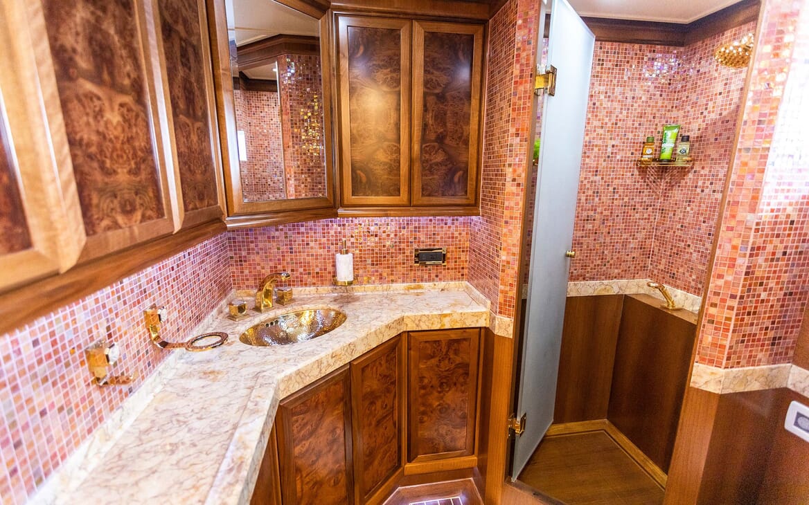 Motor yacht Milaya bathroom with pink moasic tiles, marble top and wood cabinets
