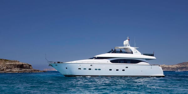 Motor yacht MEME hero shot on turquoise water and blue sky