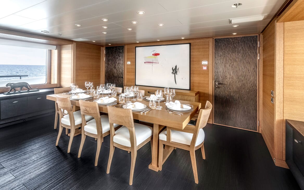 Motor yacht Spirit dining room with laid table and glassware