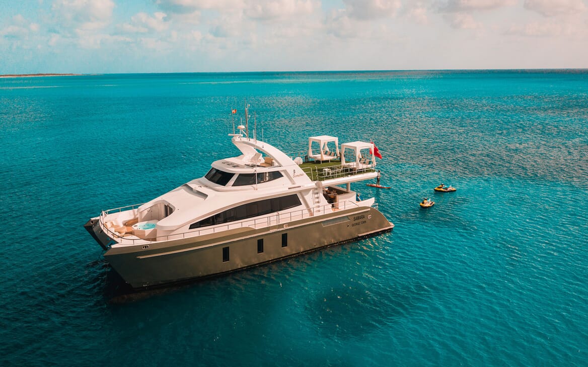 Motor yacht SAMARA aerial shot on turquoise water with jet skis