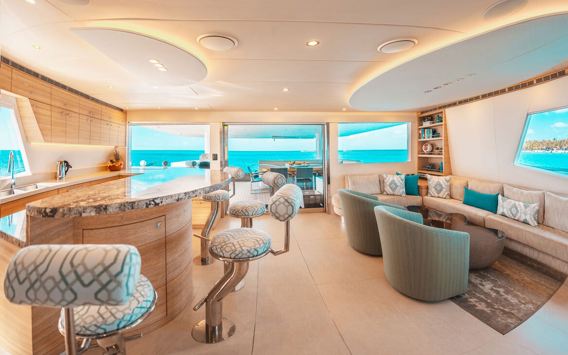 Motor yacht SAMARA living and bar area, with white and turquoise furnishings