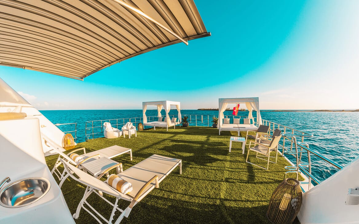 Motor yacht SAMARA deck shot with artifical grass, deck chairs and outdoor lounge matresses